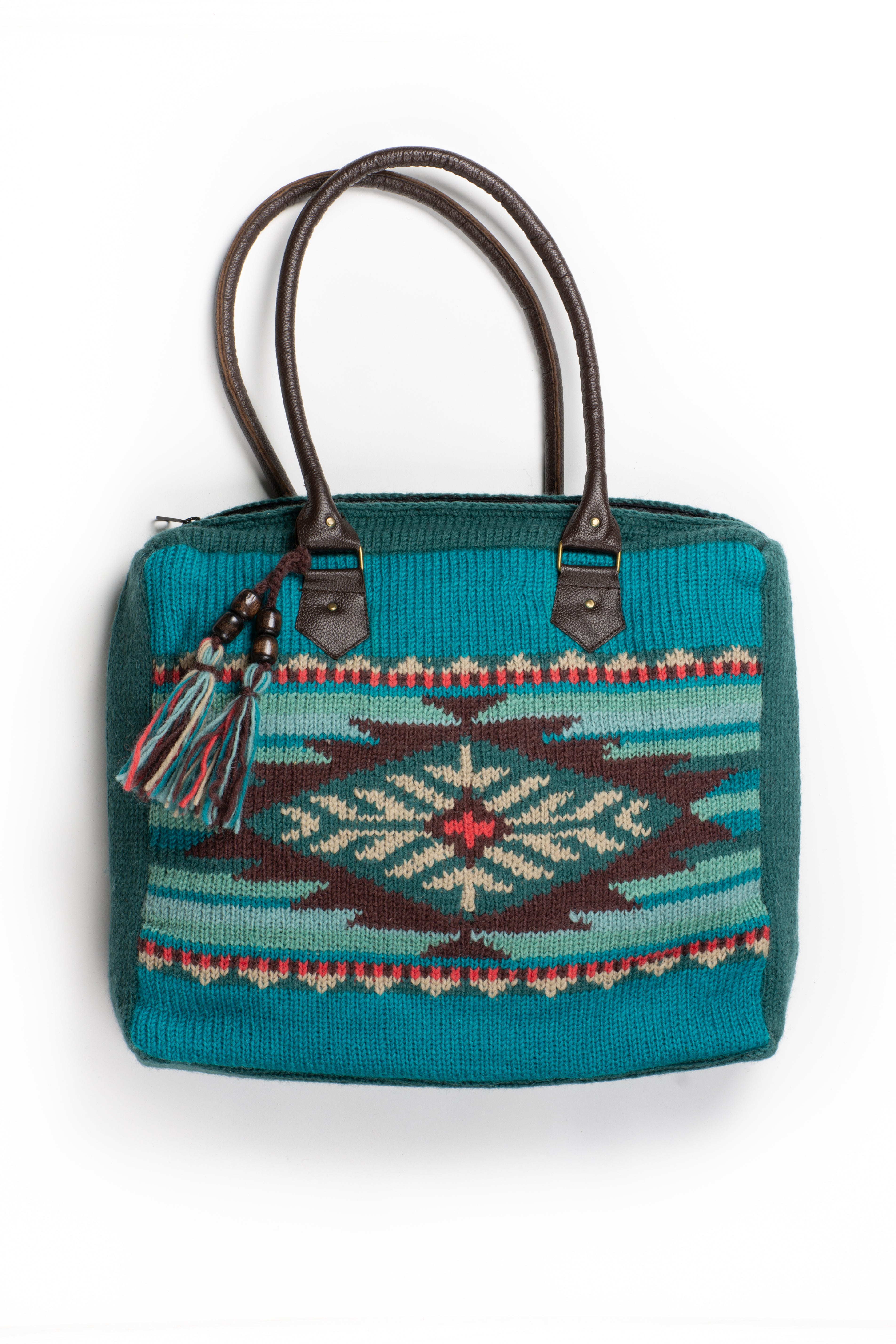 Teal knit handbag with a colorful pattern.